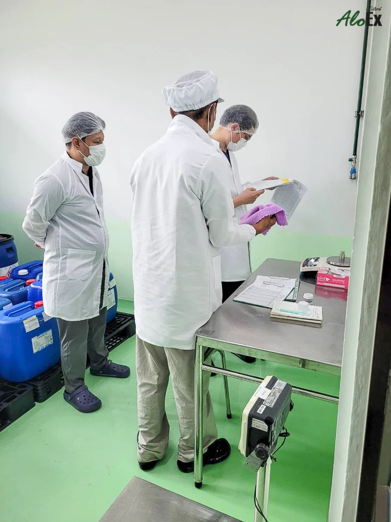 A quality-control officer reviewing documents with the auditor inside the production area